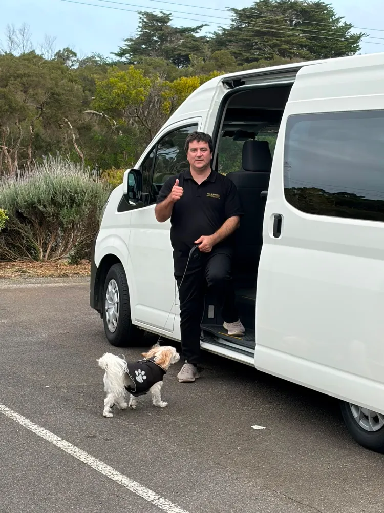Via Emmaus driver standing beside the van